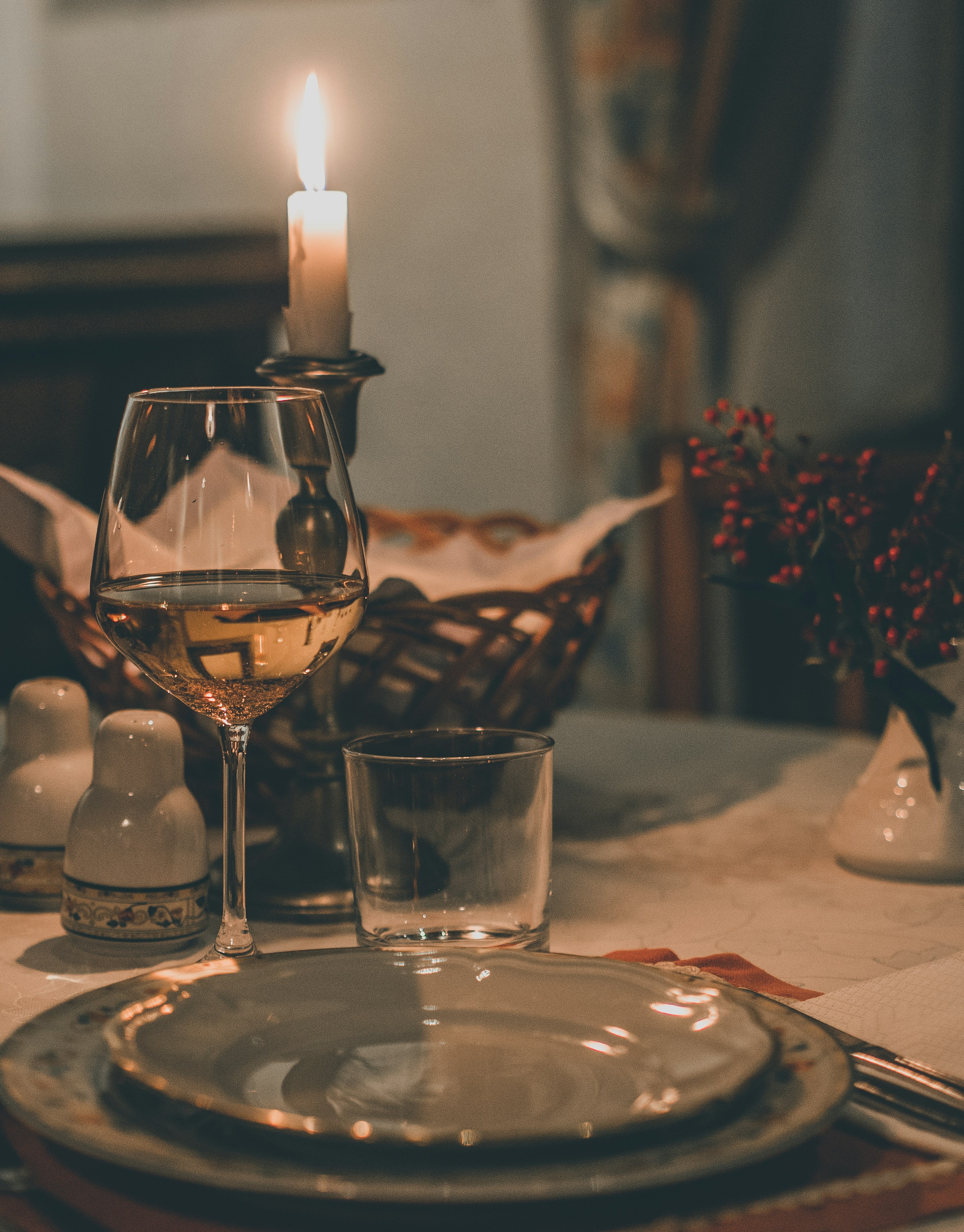 clear wine glass on red ceramic plate